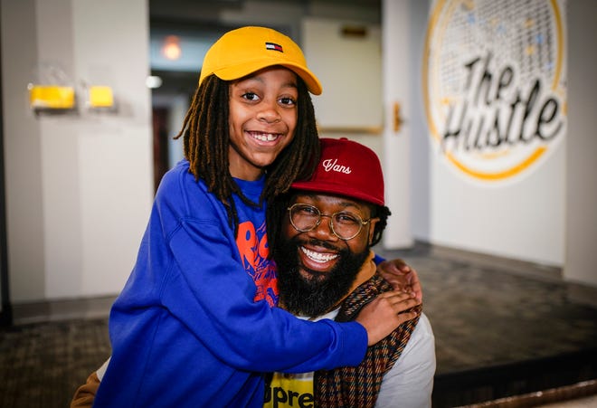 Eleazar-Yisrael Smith, 10, left, is part of the "Stories in Stereo" exhibit at the Detroit Historical Museum as his father Emmanuel Smith, 43, has an installation right next door. The two were photographed together at the museum on Friday, Feb. 23, 2024.