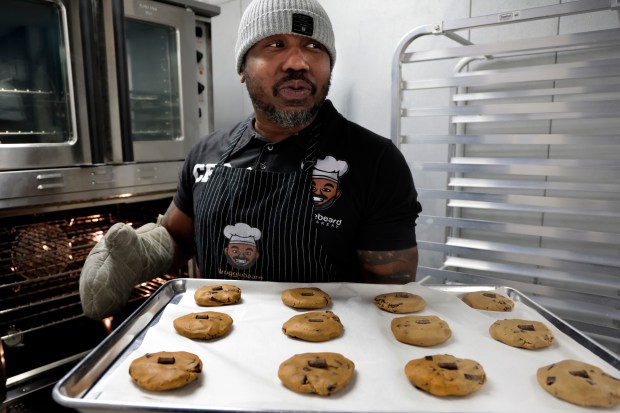 Quinton McNair, Army veteran and Strugglebeard Bakery owner, with a tray of vegan chocolate chunk cookies at his bakery in Chicago on Jan. 8, 2024. (Antonio Perez/ Chicago Tribune)