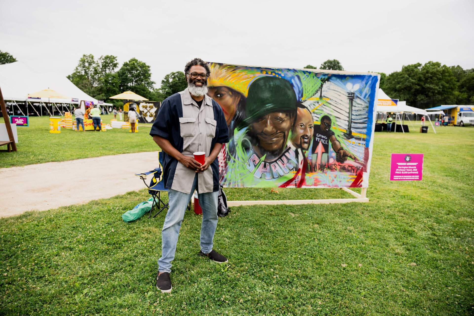 Barring Edwards with his mural "Urban Legends." Murals at the festival were used for photo backdrops and were sold to cover future BAMS Fest events. (Olivia Moon Photography for WBUR)